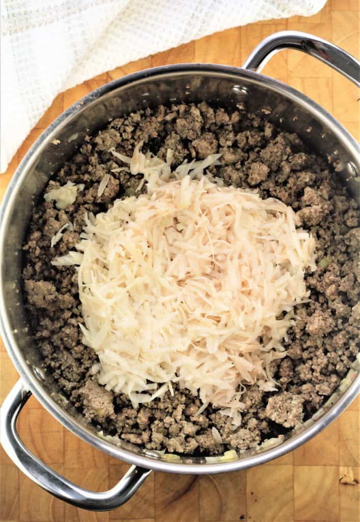 grated potato to be stirred into ground meat in sauce pan