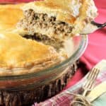 wedge of tourtière being cut and served