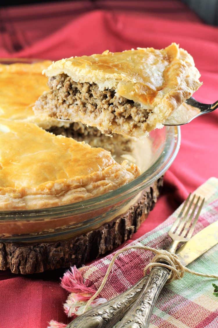 slice of tourtière being cut and served