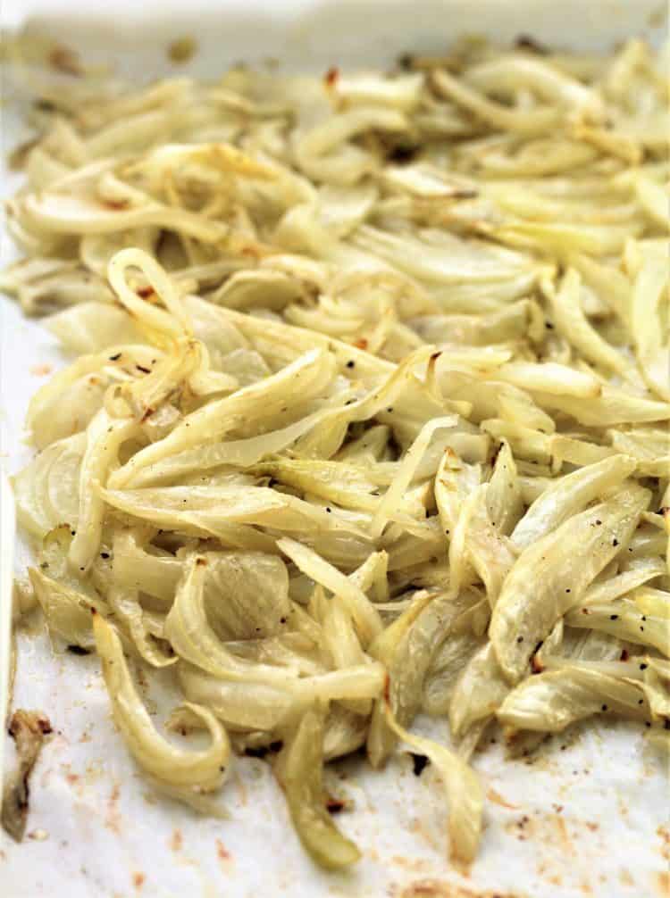 caramelized slices of roasted fennel on parchment paper