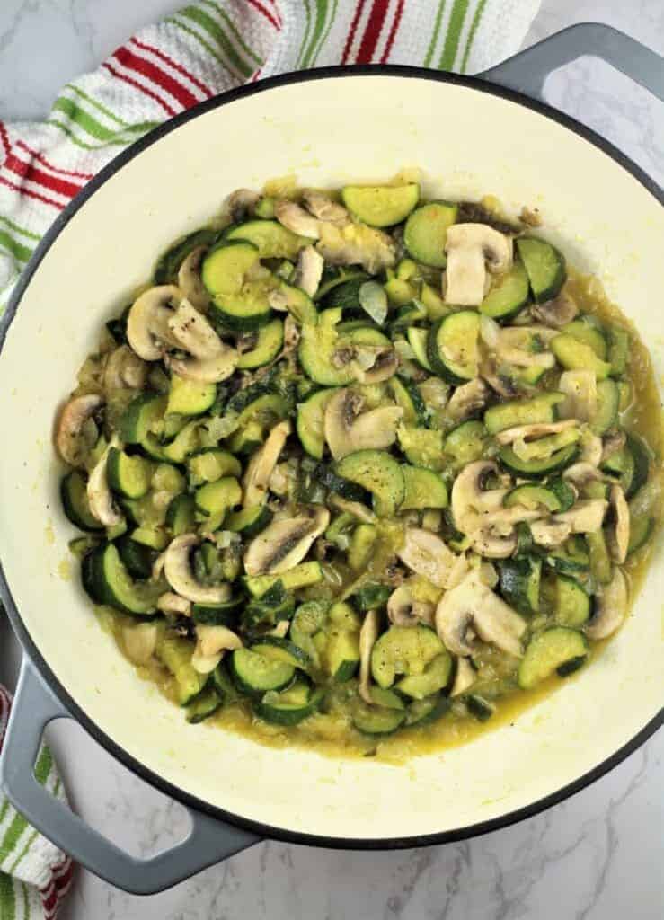 Sautéed zucchini and mushrooms in skillet for pasta.