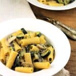 Zucchini mushroom pasta in bowl next to second bowl of pasta.