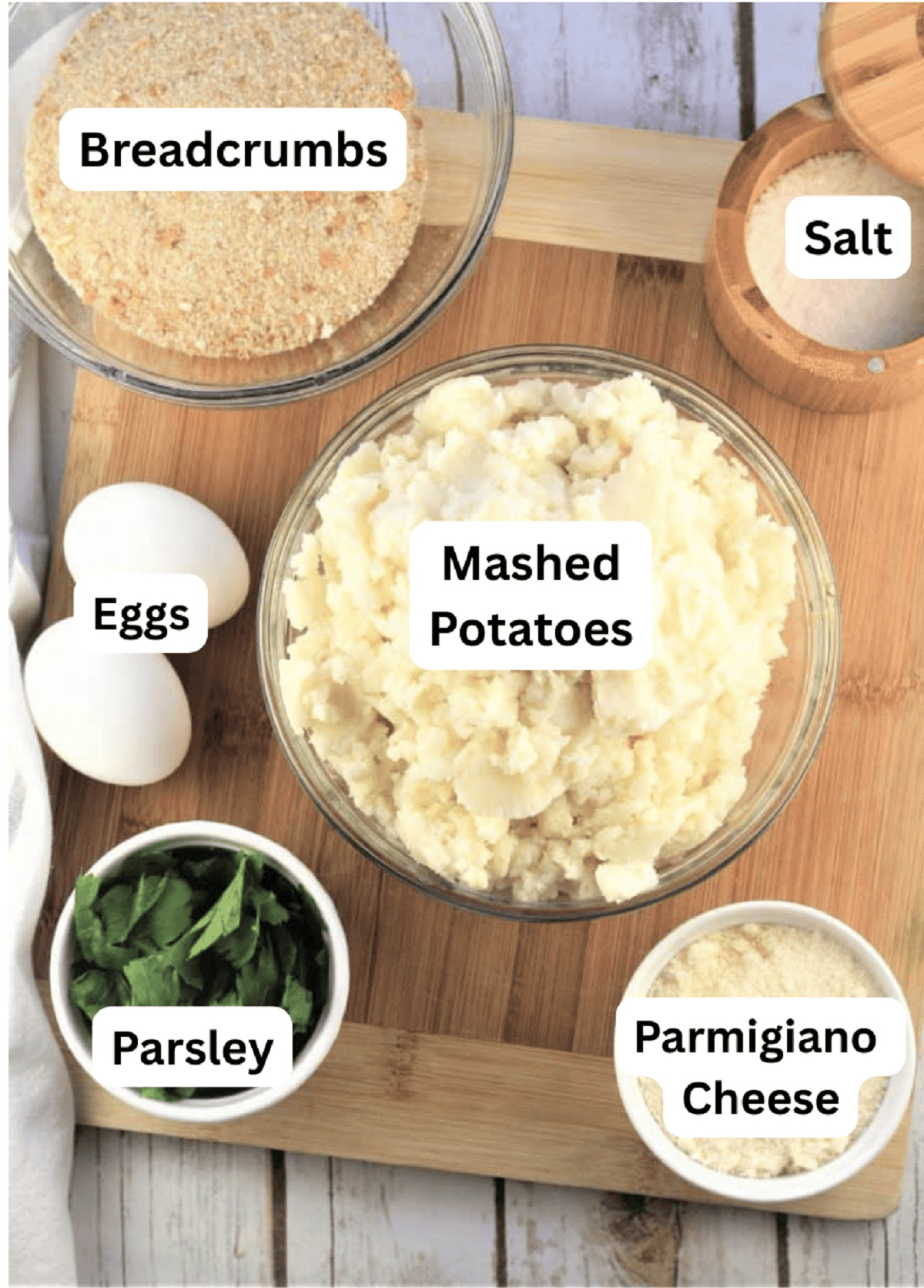 Bowl of mashed potatoes, Parmigiano cheese, parsley, eggs, breadcrumbs and salt.