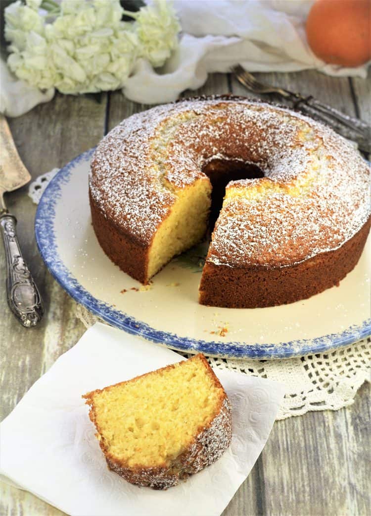 orange ciambella with a slice cut and served