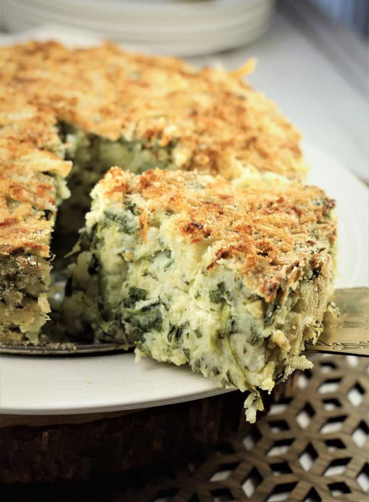 wedge of potato gateau being cut 