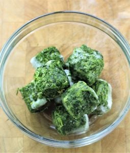 cubes of frozen spinach in glass bowl