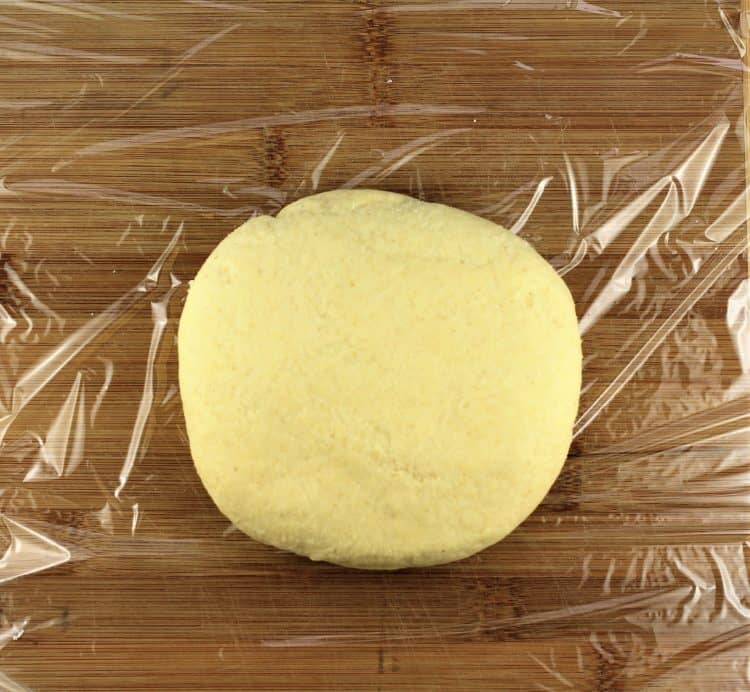ball of semolina dough on plastic wrap