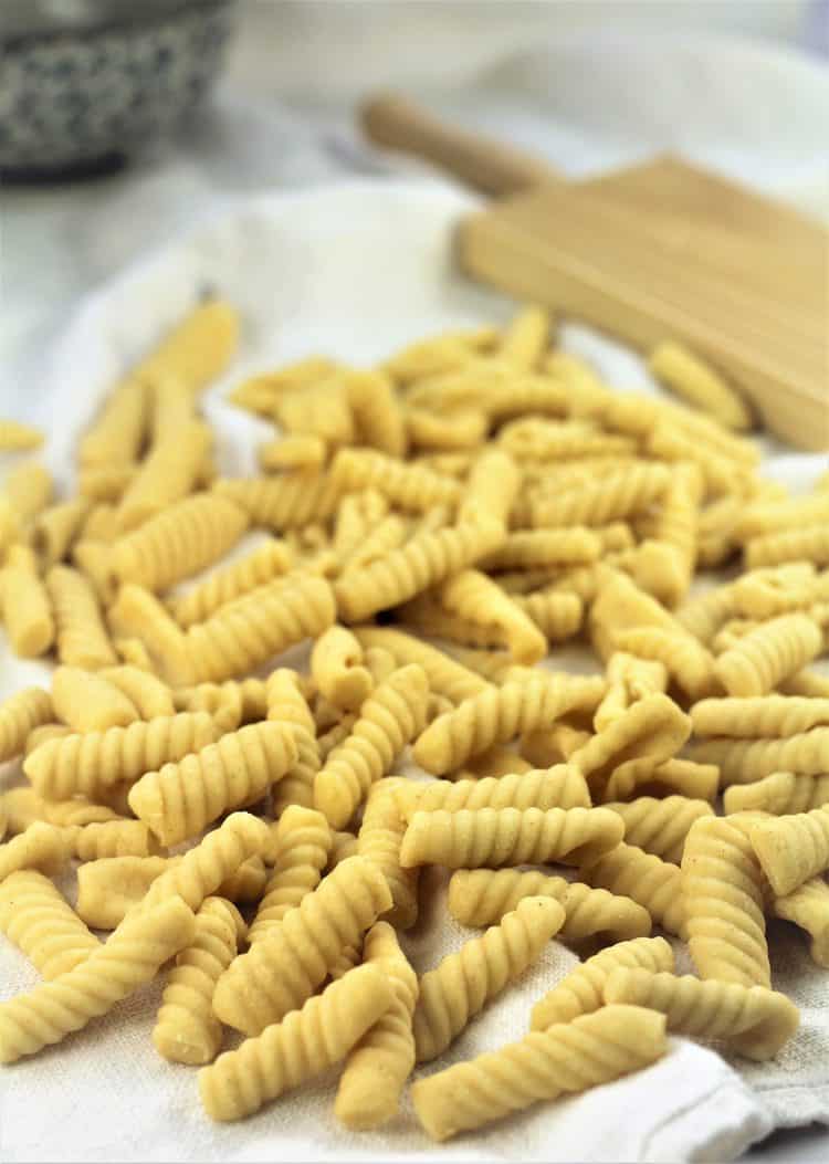 pile of homemade cavatelli with gnocchi board in background