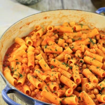 blue pan filled with pasta with chickpeas in tomato sauce