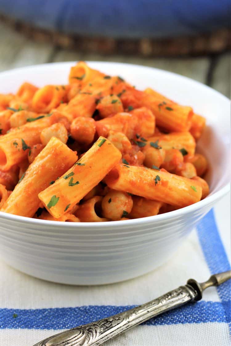 white bowl filled with pasta with chickpeas in tomato sauce