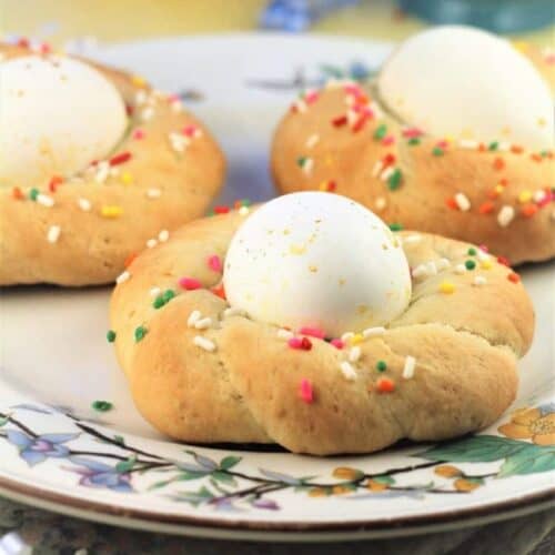 Sicilian Easter cookies with eggs in the center on plate.