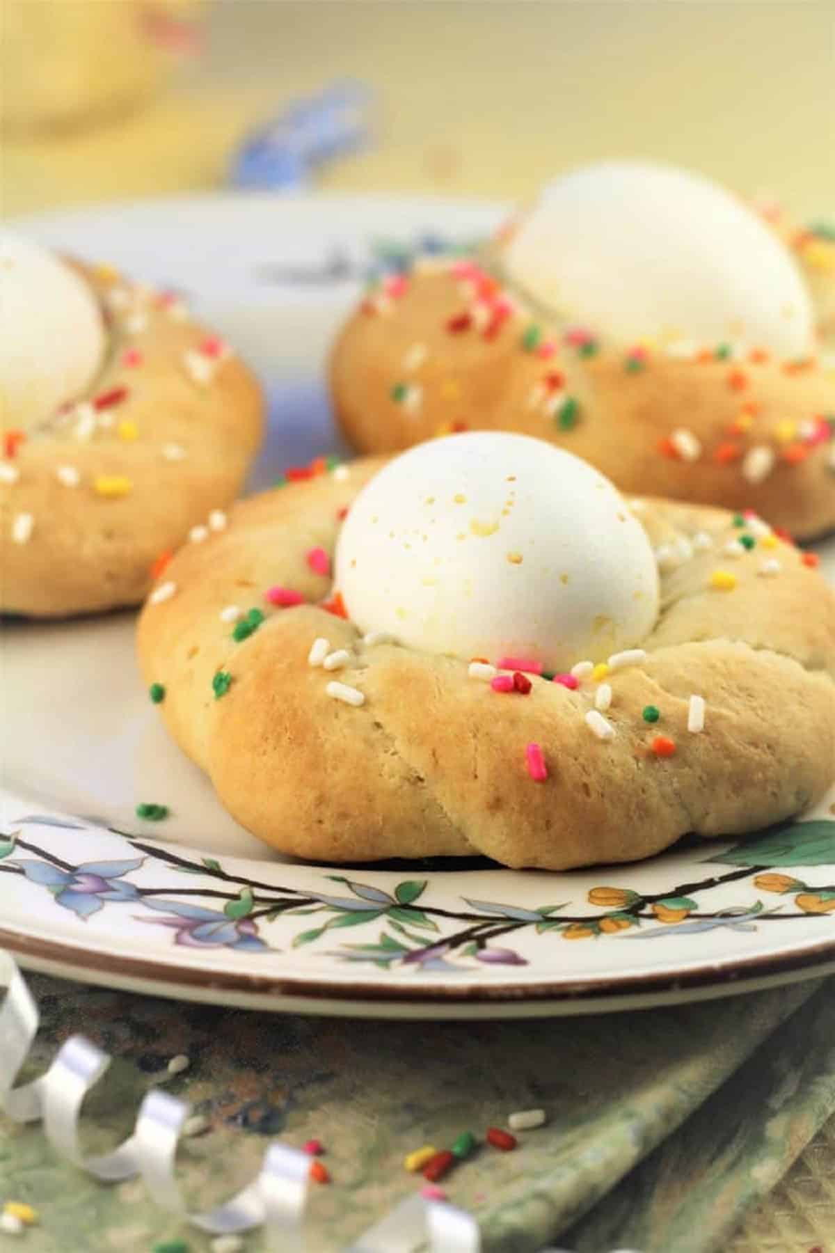 Sicilian Easter Cookies with Eggs Plated Sicilian Easter cookies with eggs and sprinkles.