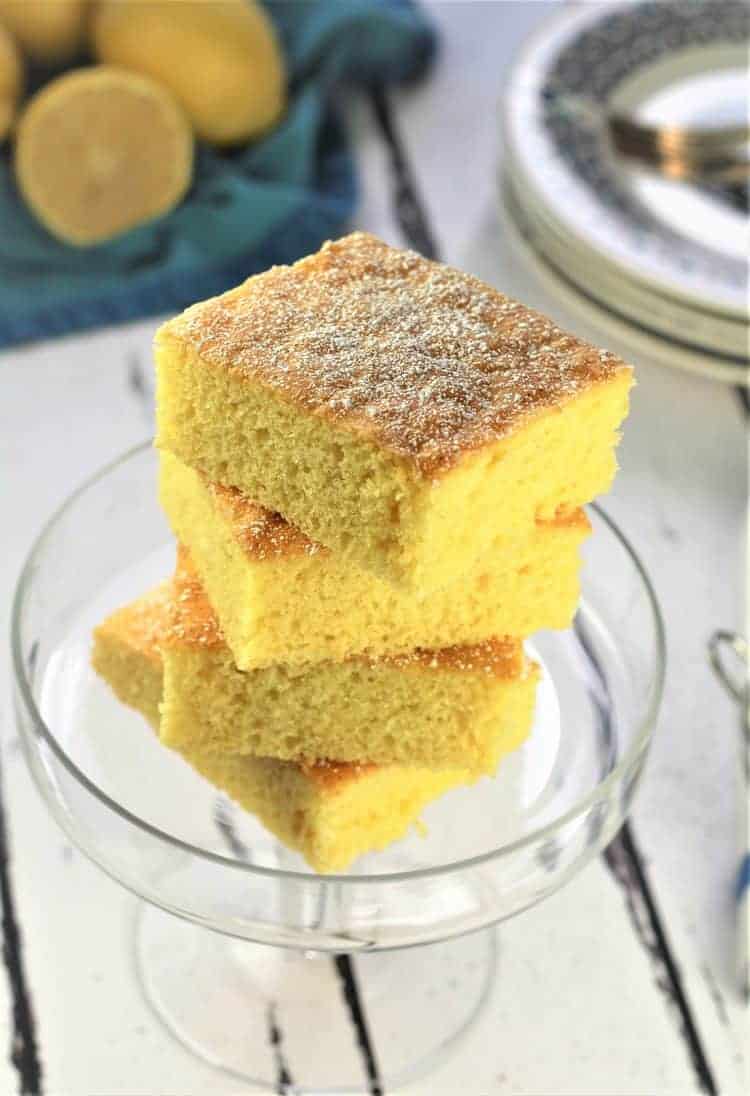 Lemon-Vanilla Snack Cake Lemon vanilla slab cake cut into squres in glass bowl.