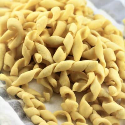 pile of homemade busiate pasta on dish cloth