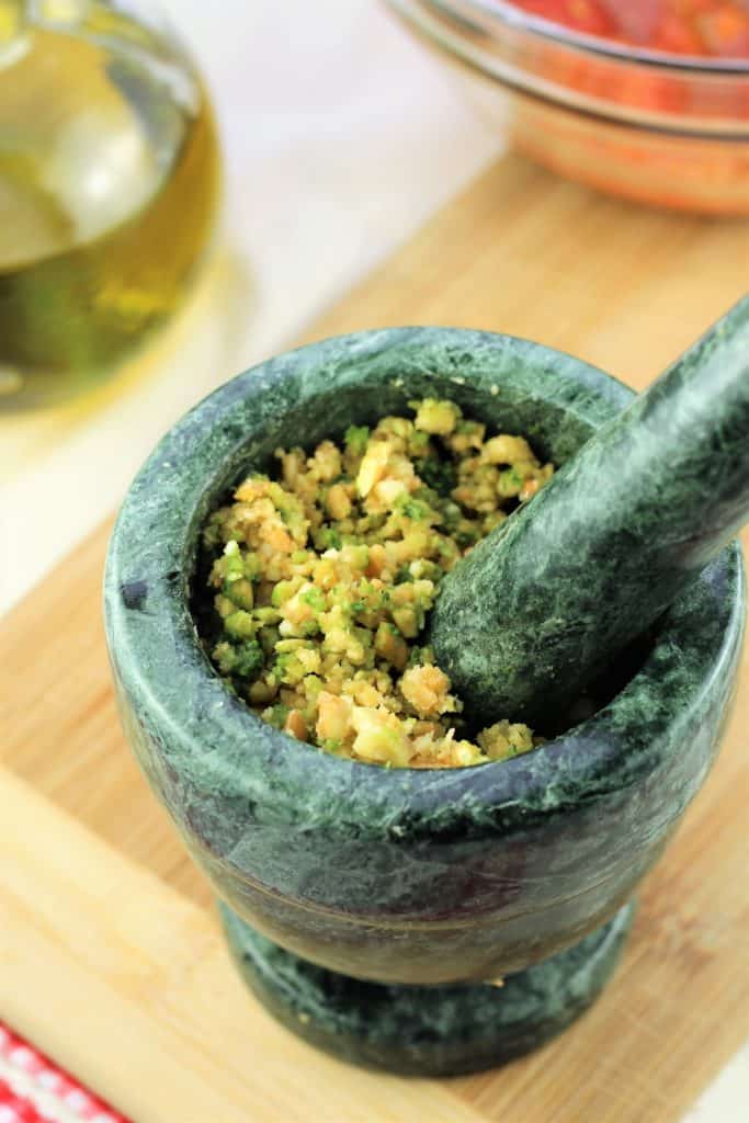 almonds and basil ground in mortar and pestle