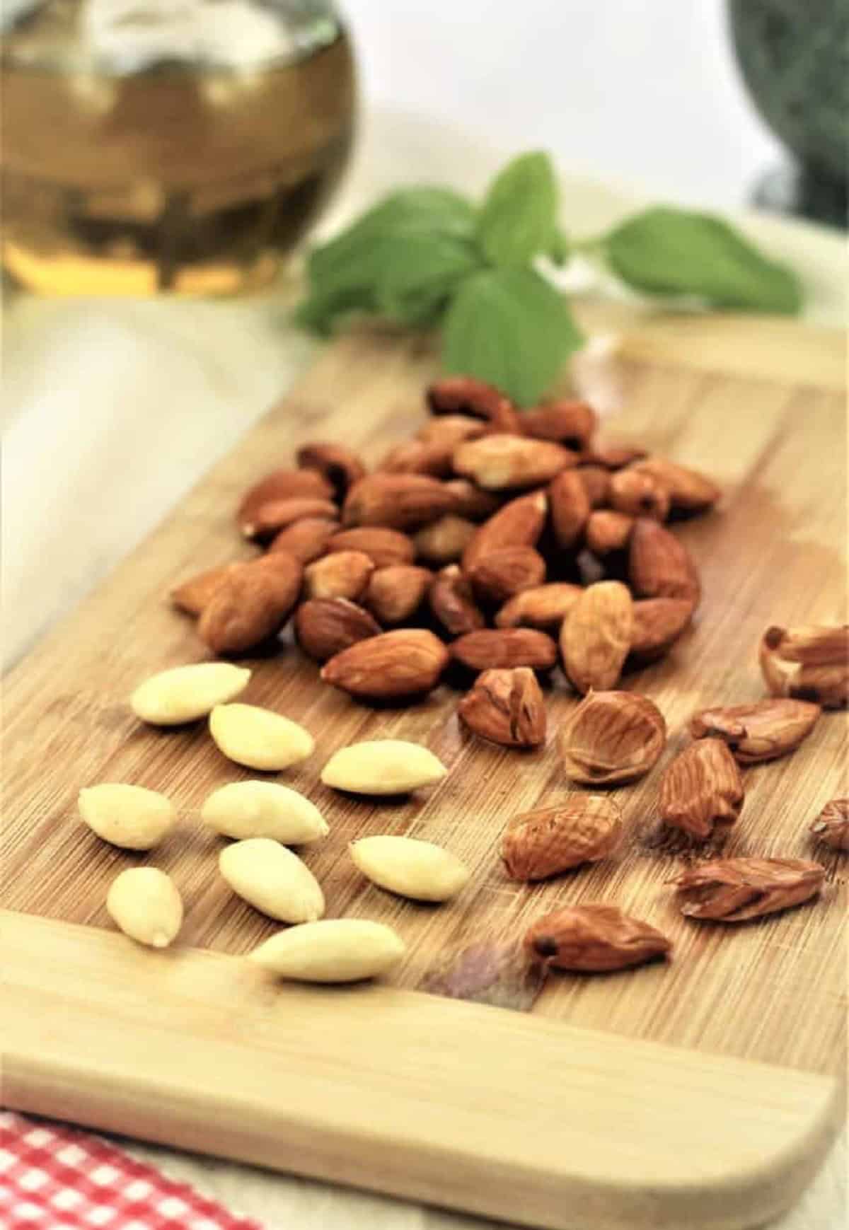 Blanched almonds with skin peeled on wood board for pesto alla Trapanese prep.