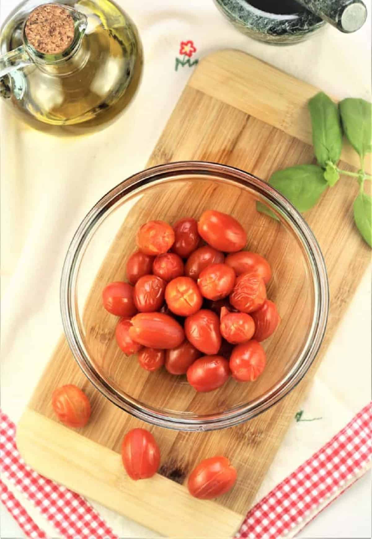 Blacnhed cherry tomatoes in bowl for pesto alla Trapanese.