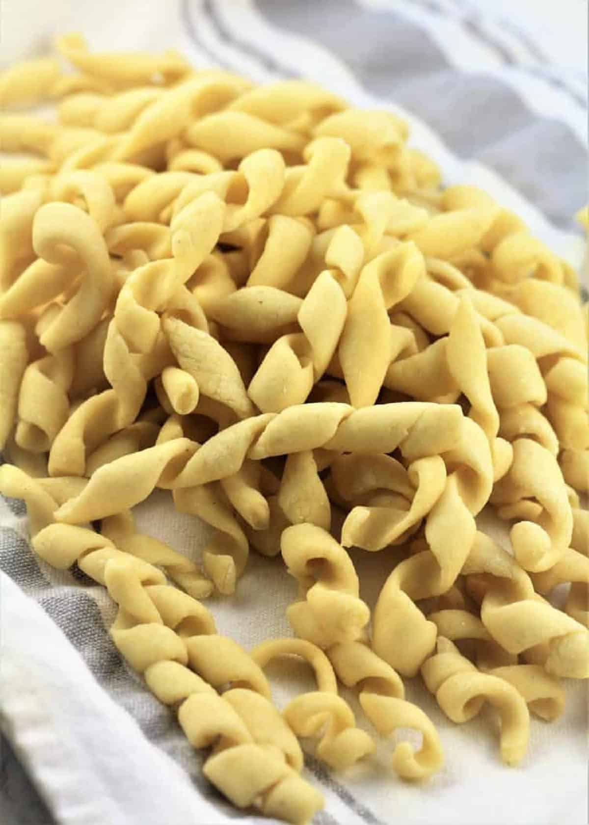 Pesto alla Trapanese (Sicilian Pesto) Sicilian busiate pasta on tea towel.