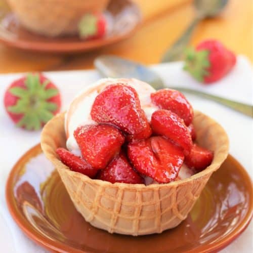 waffle cone cup with vanilla ice cream topped with balsamic strawberries