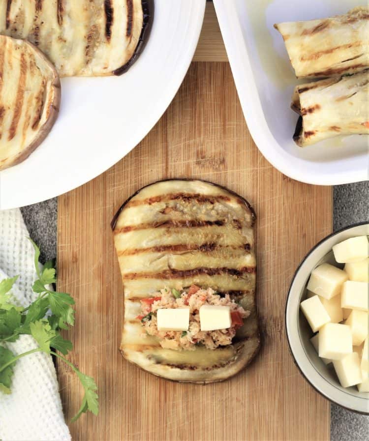 process of filling eggplant slices with breadcrumb and cheese filling