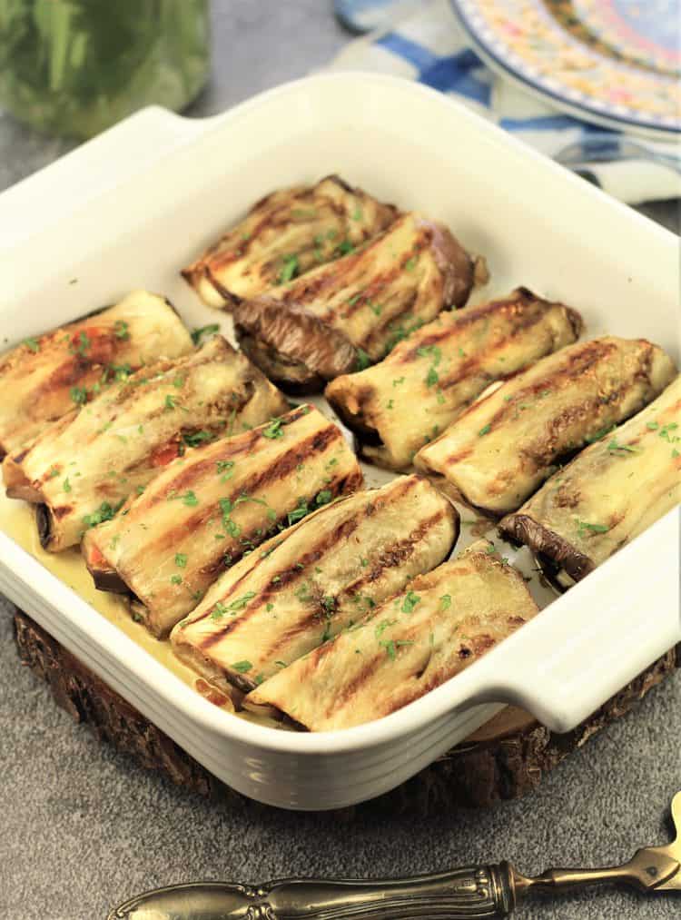 grilled eggplant involtini in a white square baking dish