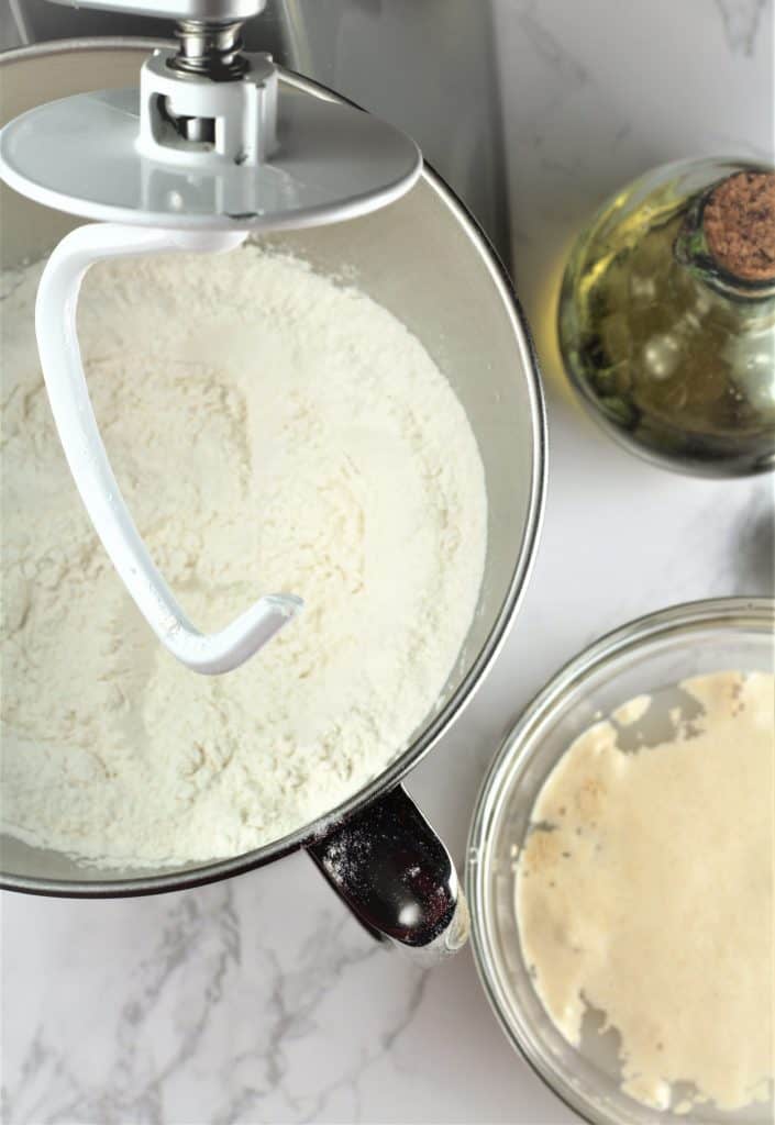 yeast proofing in bowl with flour in stand mixer bowl