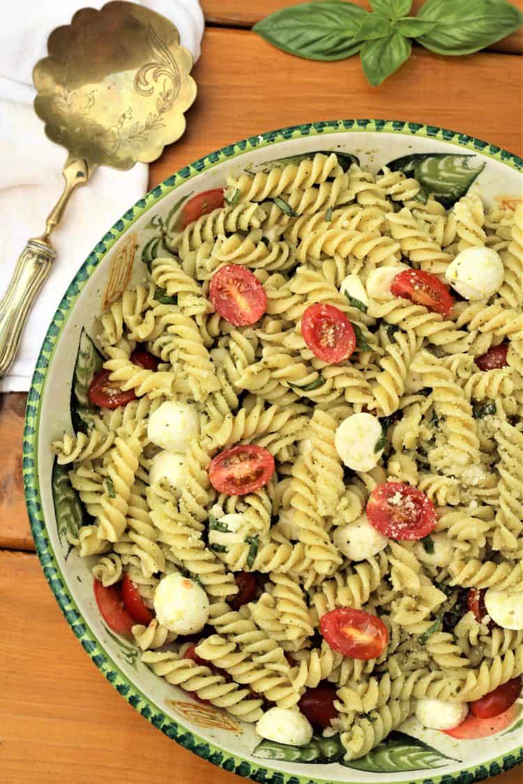 large bowl filled with Caprese pasta salad with pesto 