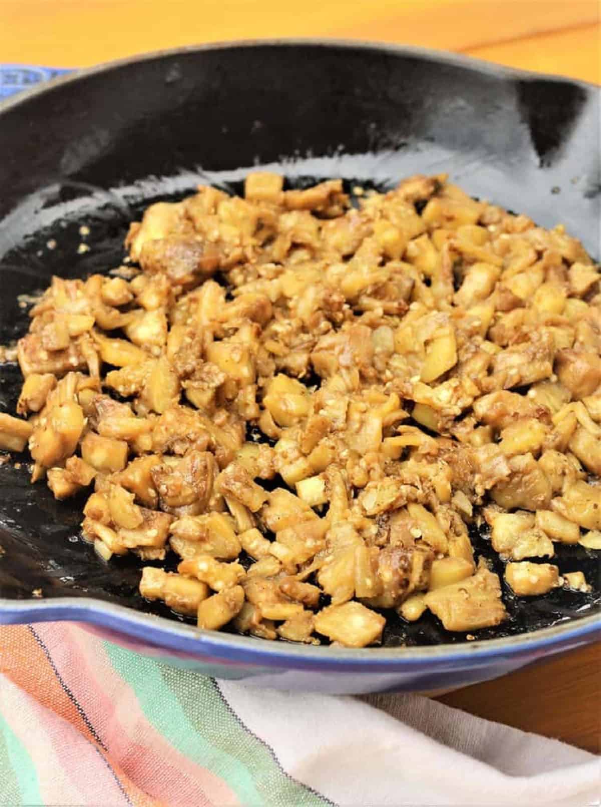 Eggplant flesh in pieces sautéed in skillet for stuffing.
