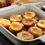 maple roasted peach halves in square baking dish