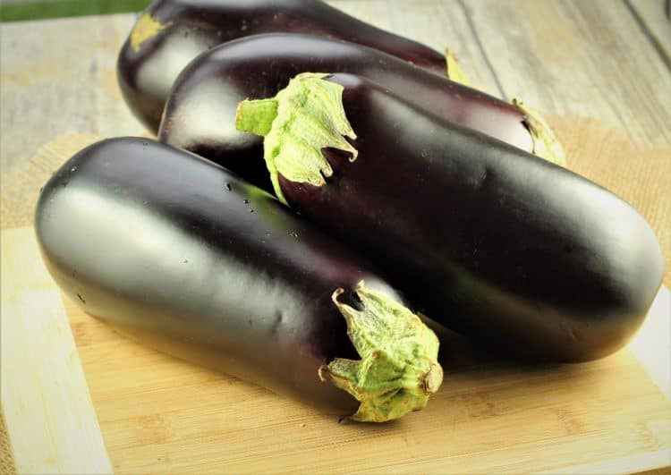 globe eggplants on cutting board