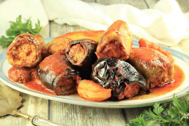 platter filled with Stuffed Eggplant and Peppers in Tomato Sauce