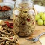 jar of pickled eggplant with fork and crostini on side