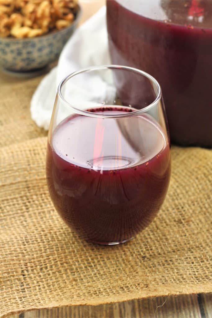 glass filled with murky grape must