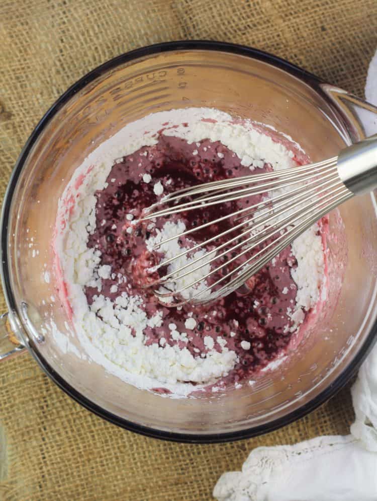 whisking cornstarch into grape must with metal whisk