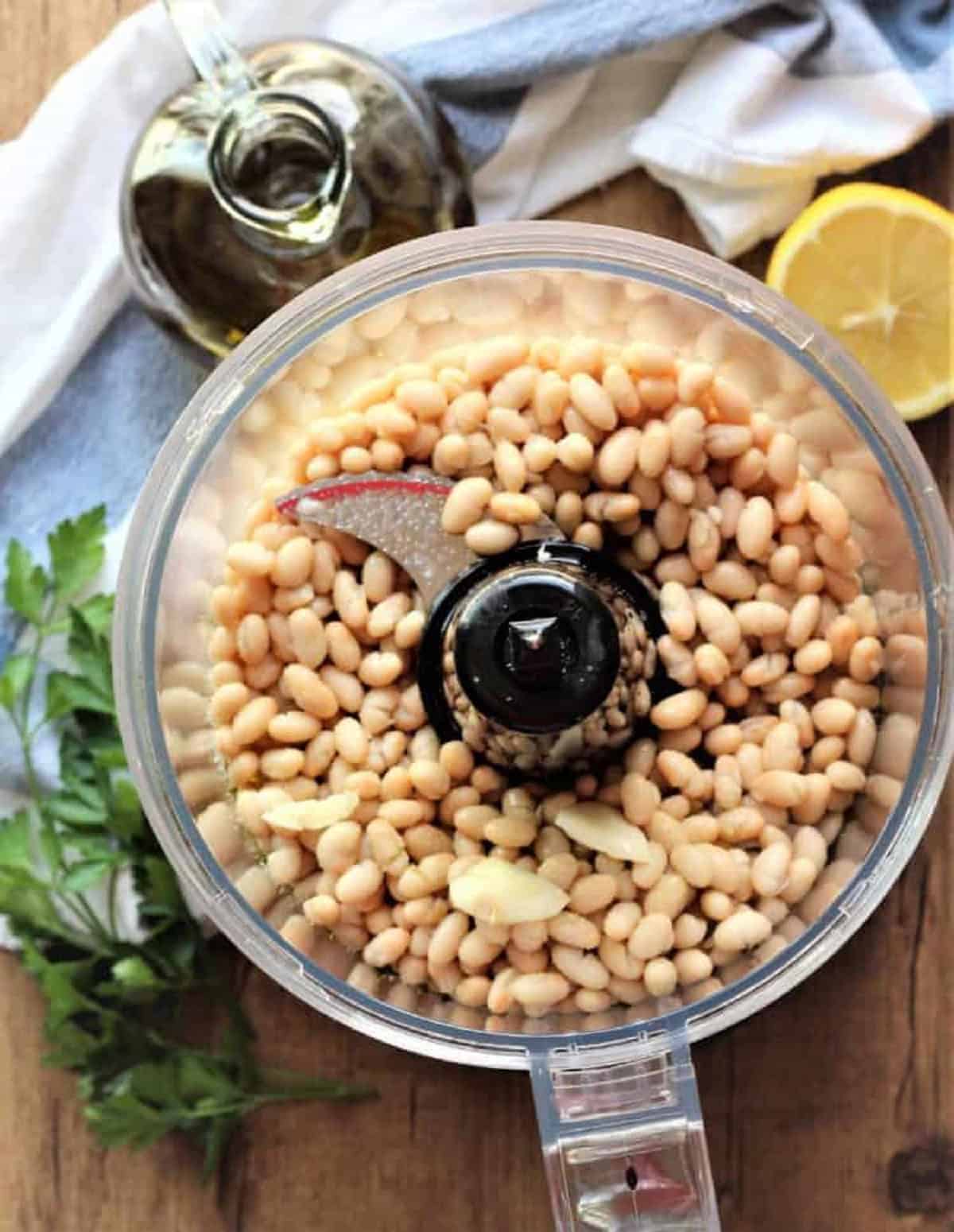 White beans in food processor bowl for white bean dip.