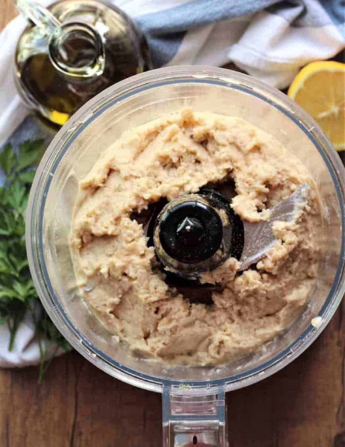 White bean dip in bowl of food processor.