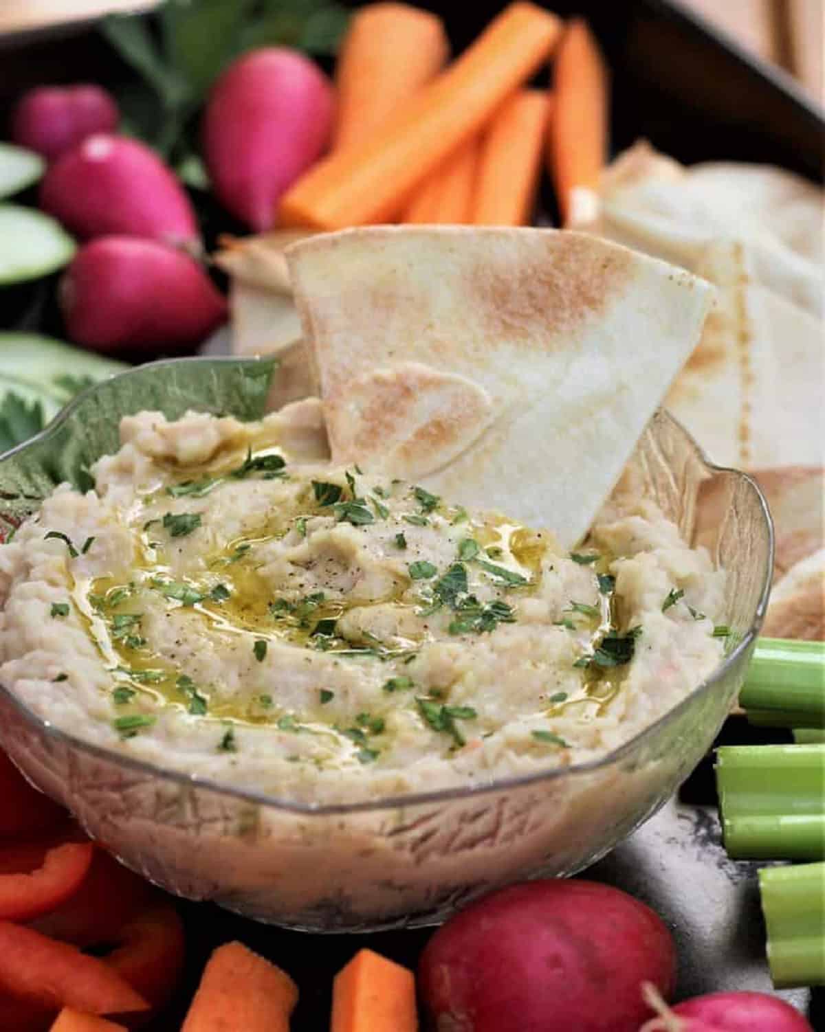 White Bean Dip Creamy white bean dip served with pita chip and crudités.