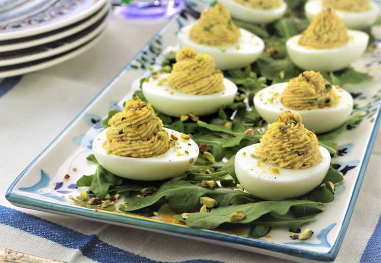 arugula covered rectangular platter of deviled eggs