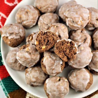 Tetù (Sicilian Chocolate Spice Cookies) on white plate with one cut open