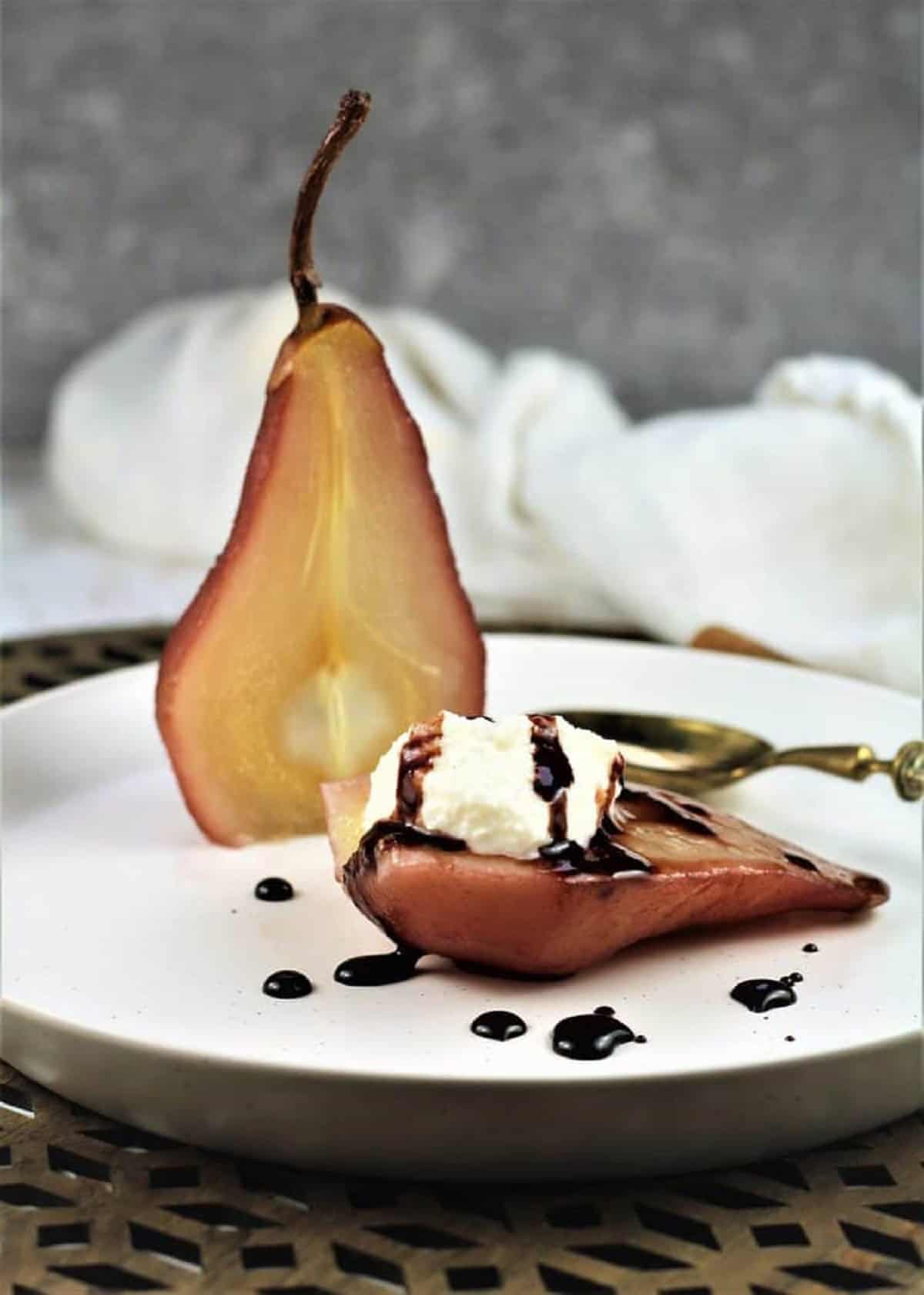 Pears Poached in Red Wine Red wine poached pear with a dollop of ricotta.