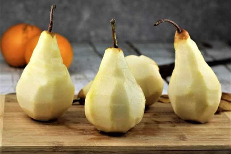 Peeled Bosc pears for poaching.