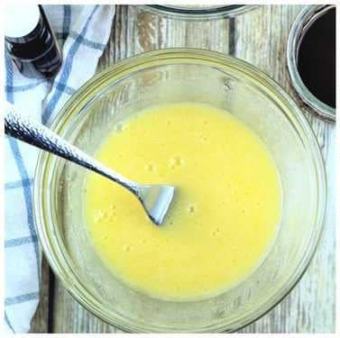 Beaten egg and sugar in bowl for chocolate espresso amaretti recipe.