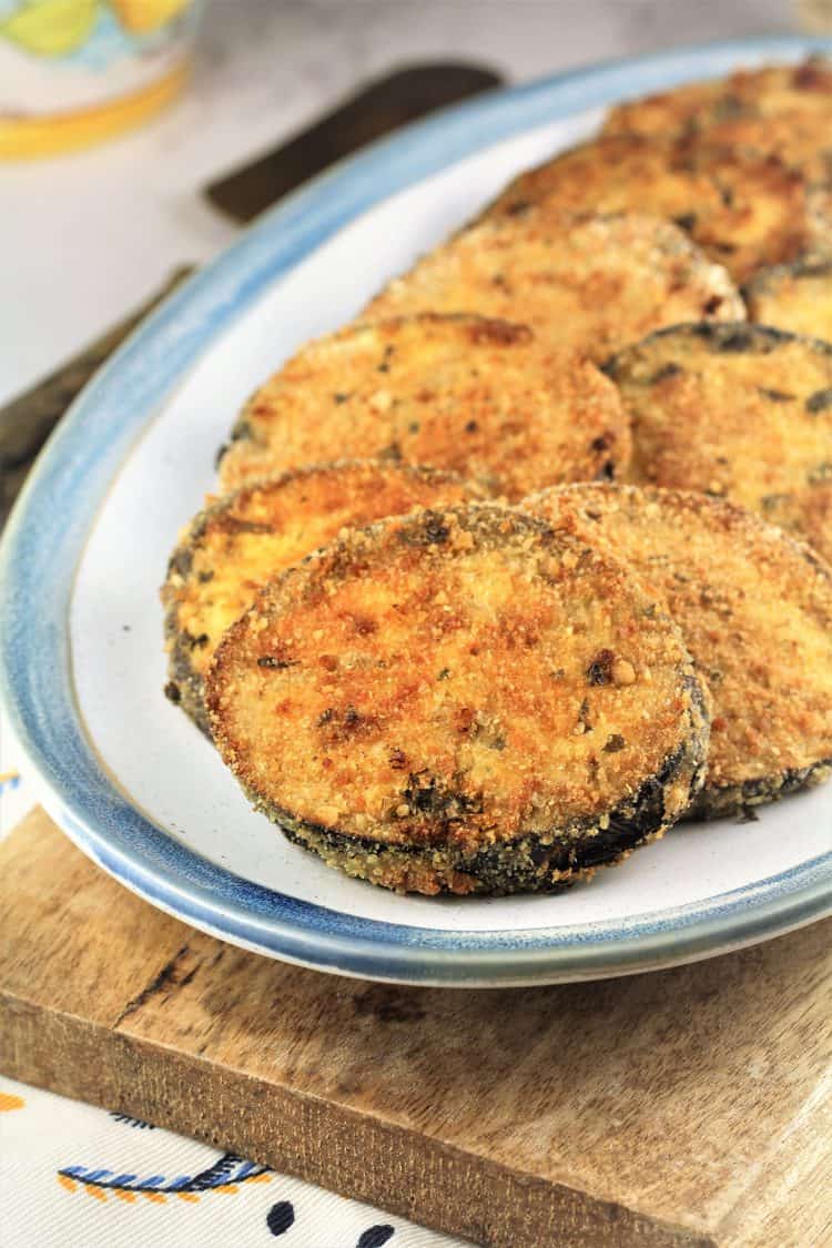 white blue rimmed plate with breaded eggplant cutlets 