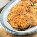 Baked breaded eggplant cutlets on serving plate.