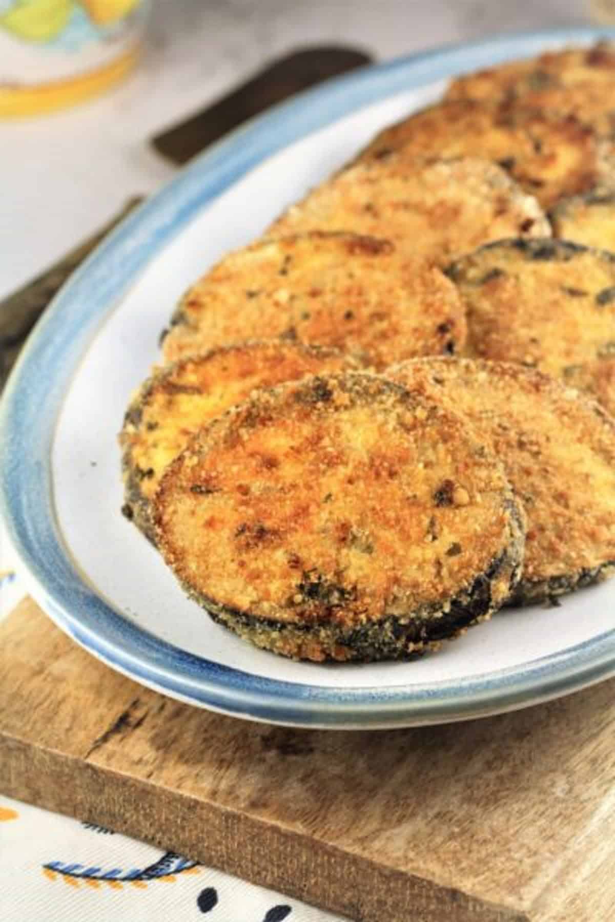 Baked breaded eggplant cutlets on serving plate.
