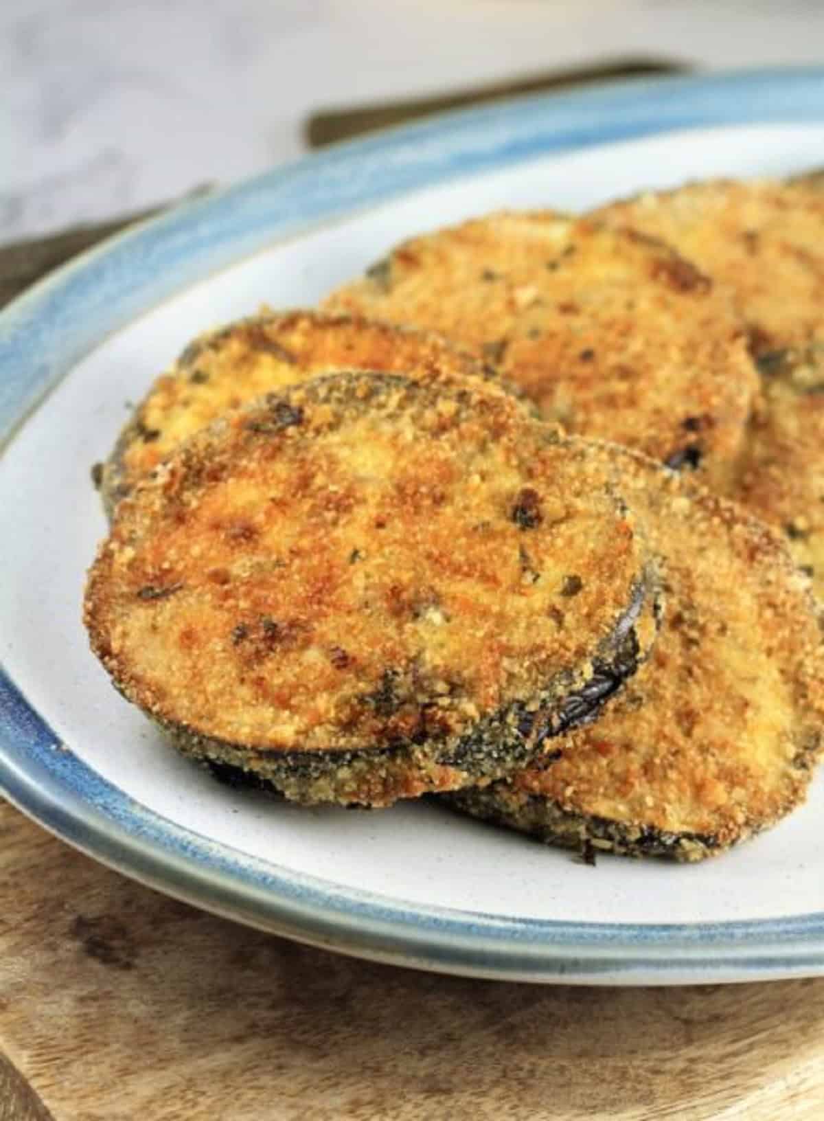 Breaded eggplant cutlets on plate.