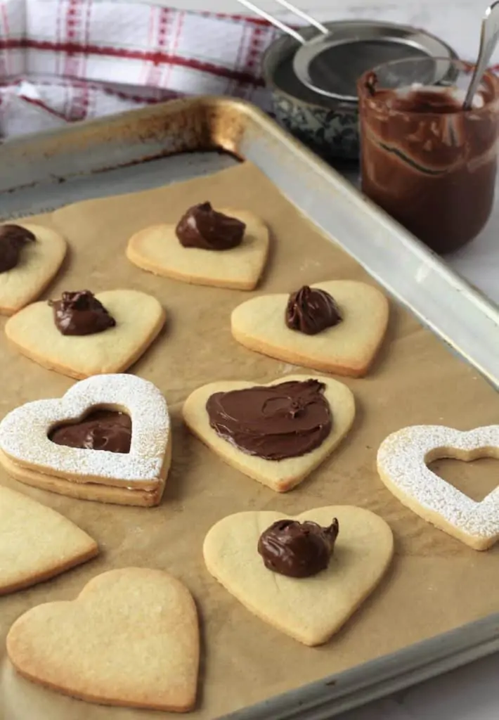 spreading Nutella on heart shaped cookies 