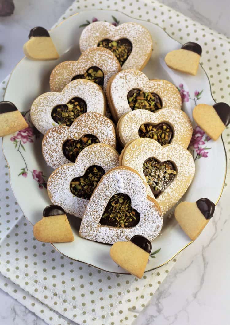 white oval plate filled with heart shaped cookies