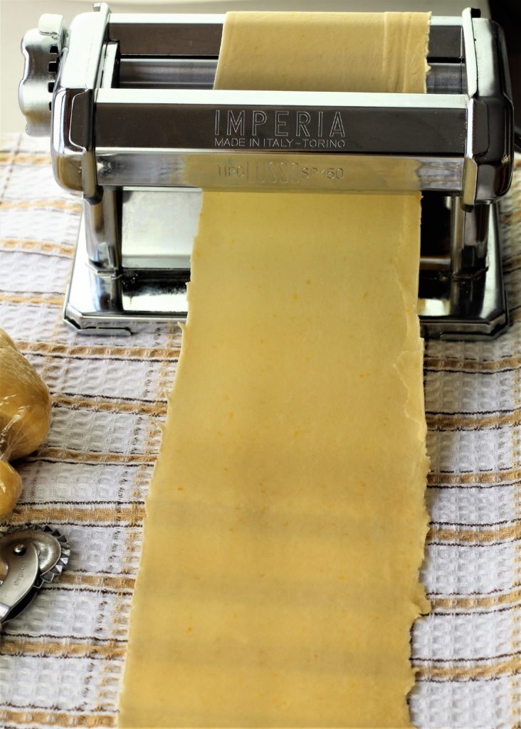 pasta roller shown with sheet of dough rolled 