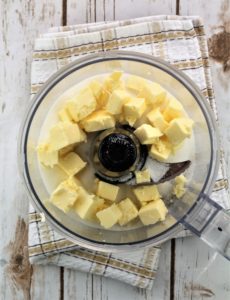 butter cubes and sugar in bowl of food processor